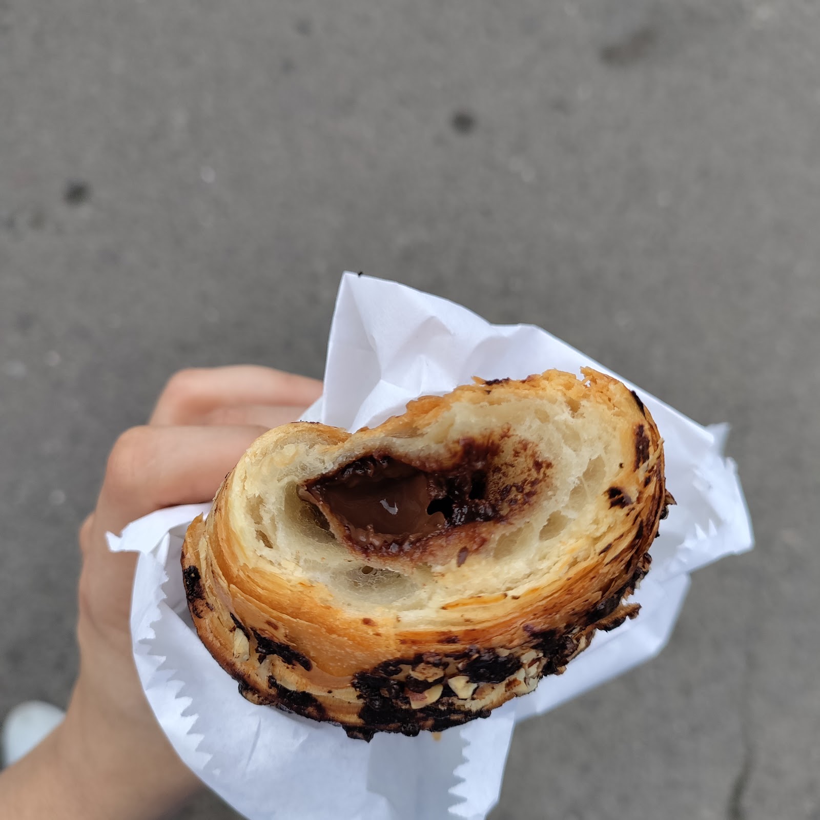 A chocolate-filled croissant in white paper